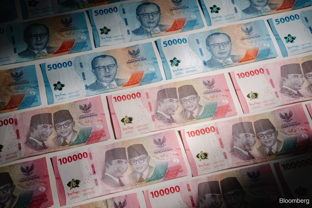 Indonesian stocks slump to five-year low, rupiah drops to record