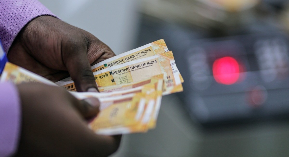 India rupee climbs on oil relief, central bank valuation comment