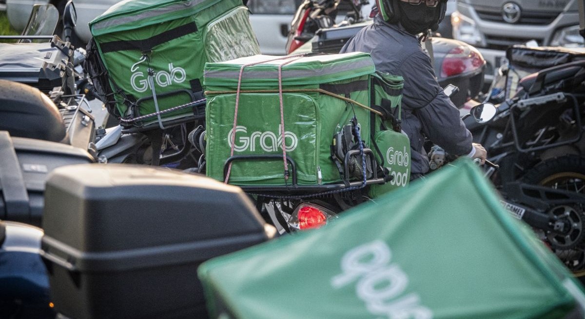 Grab brings forward profit goal after quarterly loss narrows