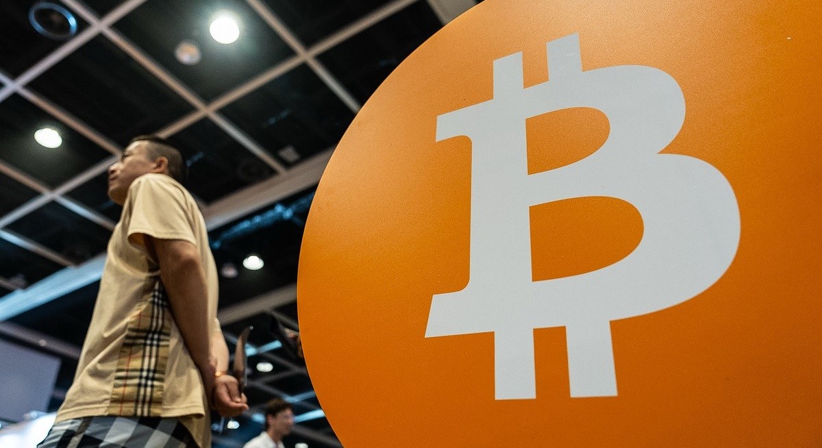 Bitcoin rises to a record as ‘debasement’ trade spurs risk rally