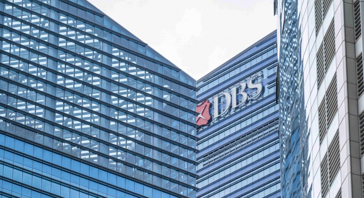 DBS shares pop at open but sink below $50 again
