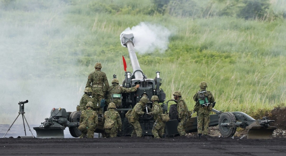 Japan scraps most curbs on exporting weapons in historic shift