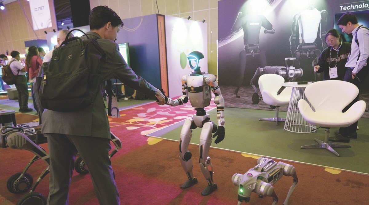 An attendee interacts with a humanoid robot made by Unitree Robotics of China at last year’s Super AI Conference in Singapore. Photo: Bloomberg
